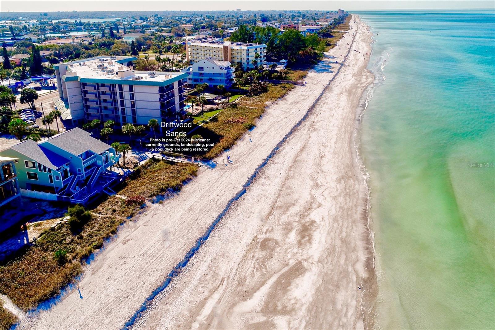 View to South of Indian Rocks Beach before Oct 2024 hurricanes. Our still gorgeous wide pale sand beach currently lacks much of the seaoats, seagrapes and vegetation in this photo.