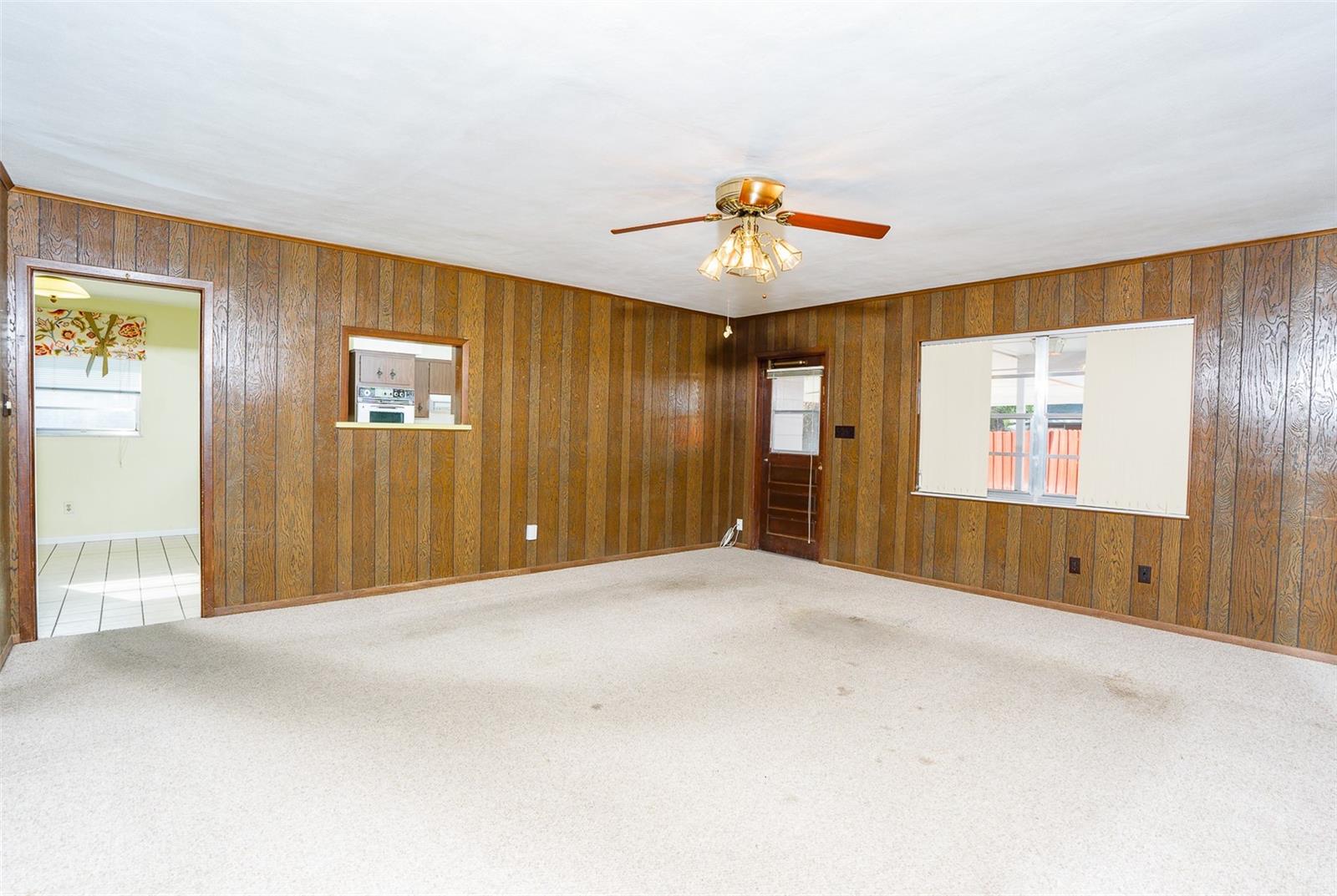 Living room with door access to patio and pool