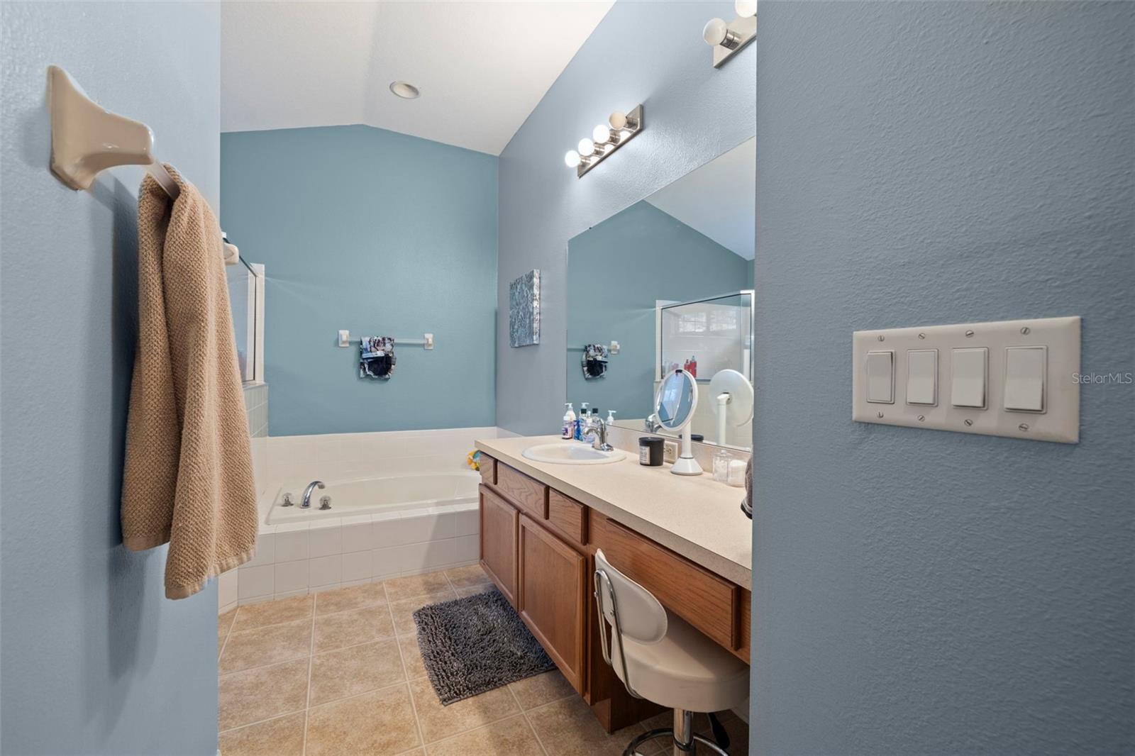 The primary bathroom has a separate soaking tub and shower stall. The vanity has plenty of room if you want to have two sinks.