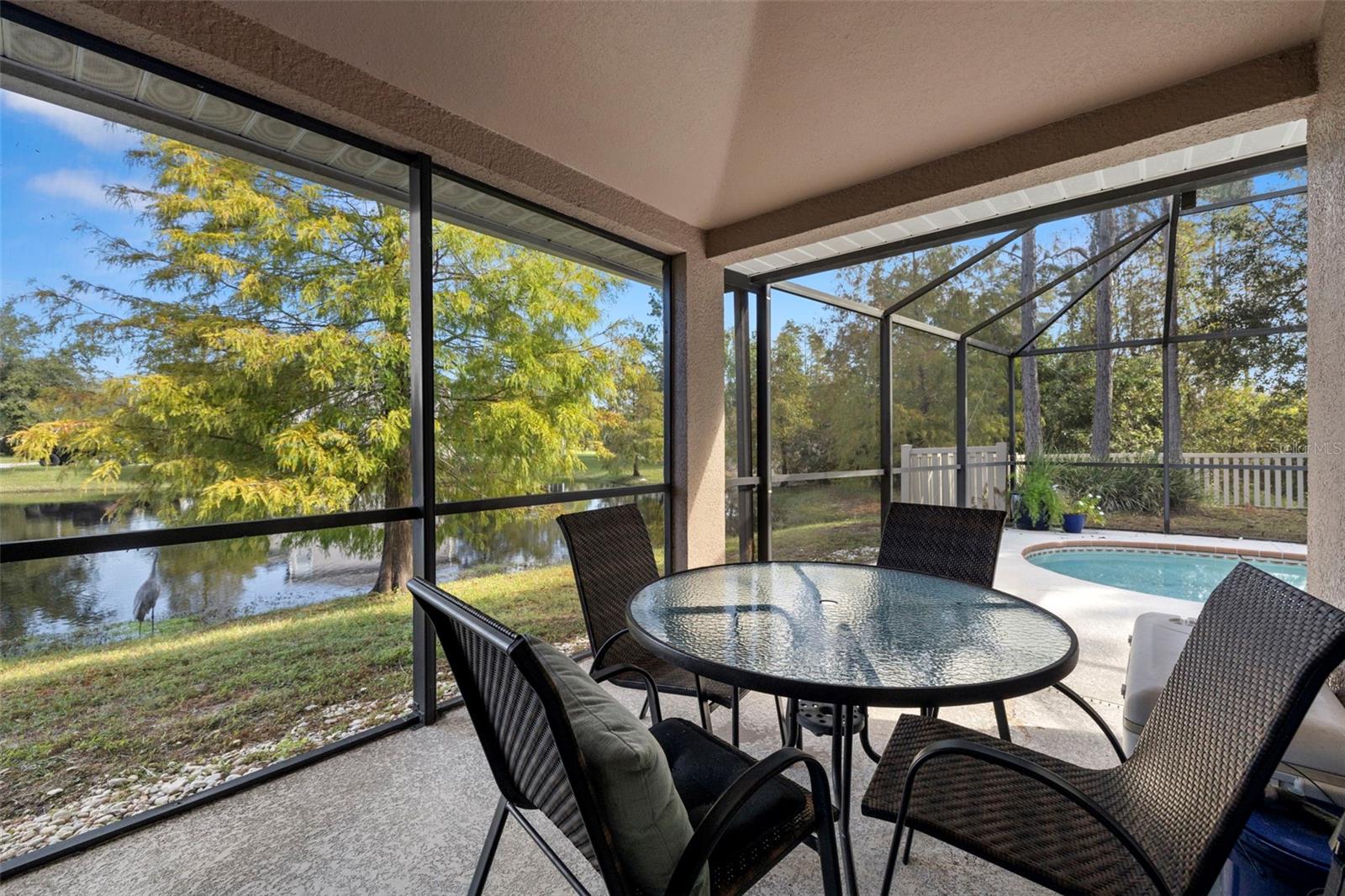 A separate and covered seating area outside on the lanai for enjoying your amazing pond views!