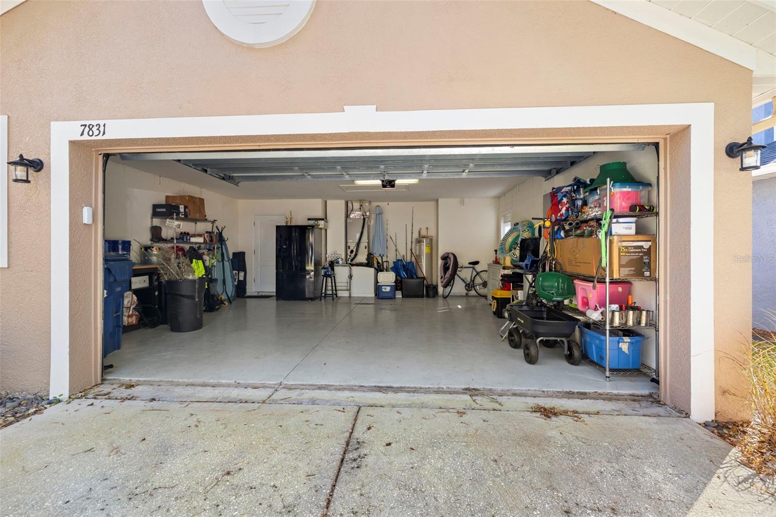 Two car garage with door to the side of the house and access to the attic in the ceiling.