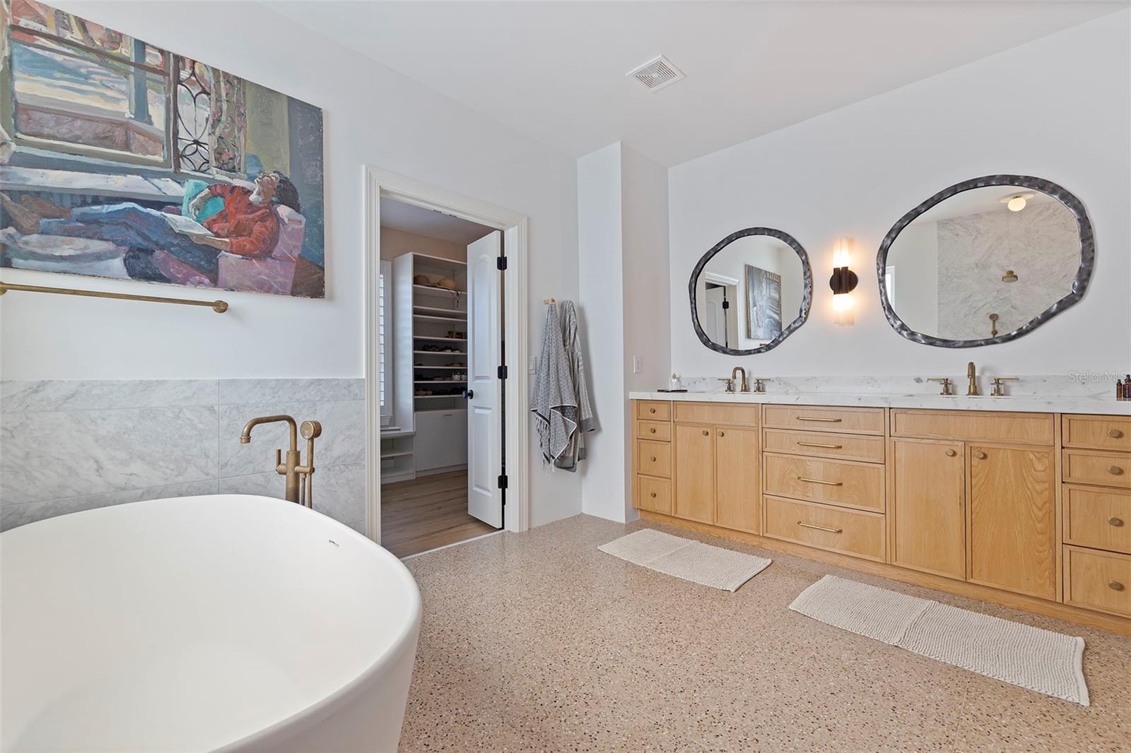 Beautiful vanity with lots of storage. Spectacular Terrazzo floors. Gorgeous marble countertop with handmade faucets.