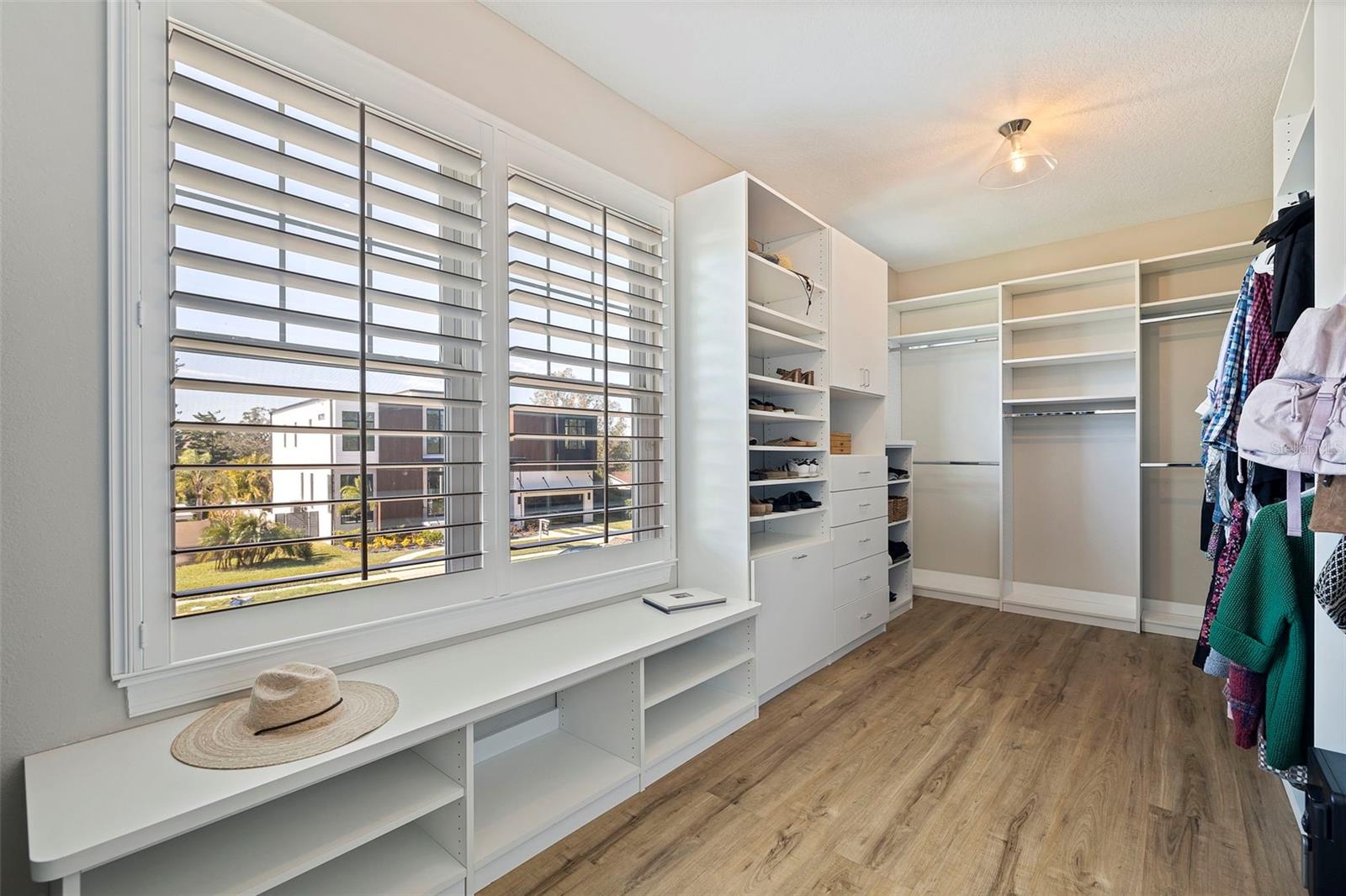 Large primary walk in closet with natural light.