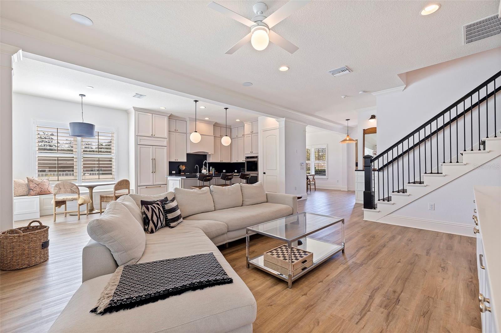 Cohesive flooring throughout the home. Lovely ironwork of the open staircase.