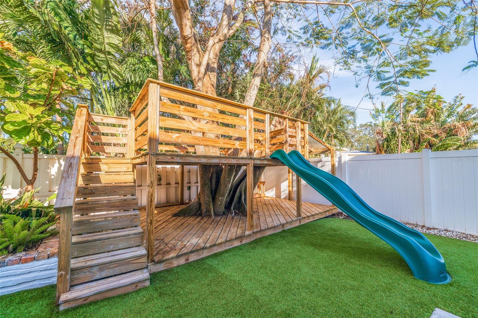 Two story tree house with slide.