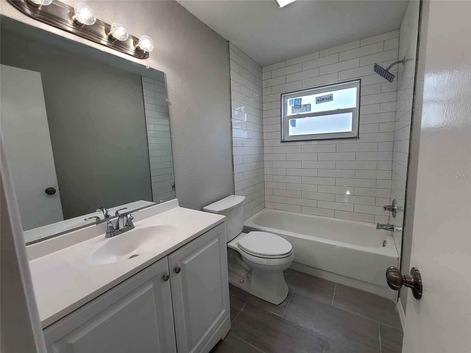 HALL BATH, NEW VANITY, NEW TOLIET, NEW TILE TUB & SHOWER