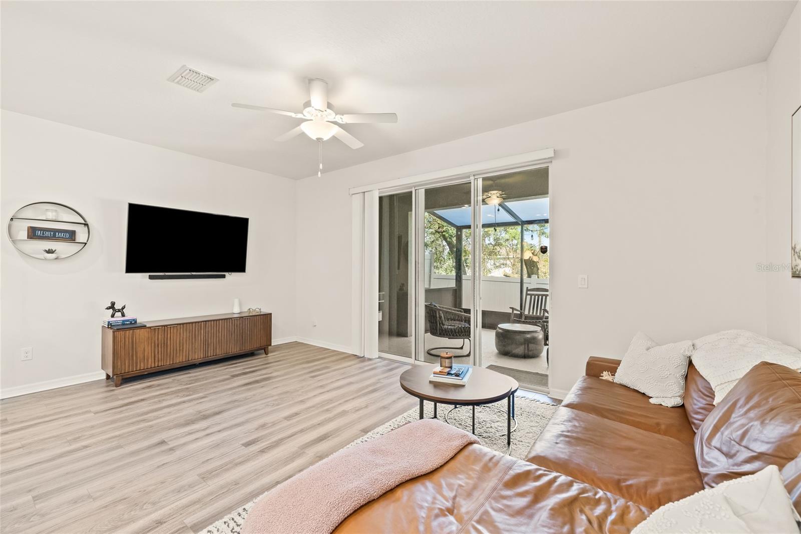 Door from living space leads to large screened in patio