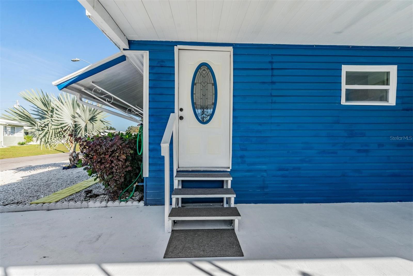 Front door located on the RIGHT side of the mobile home - giving 2 full bay windows with awning to the front.