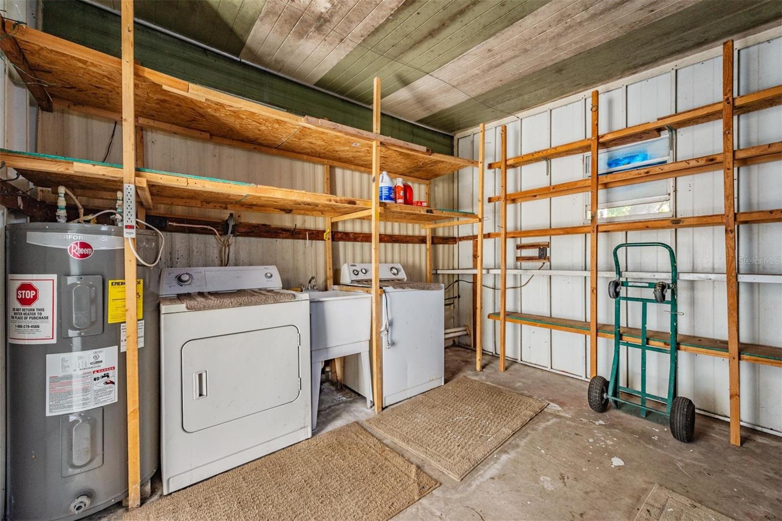 Washer/Dryer convey.  Wash tub, hot water tank, work bench and plenty of storage area.