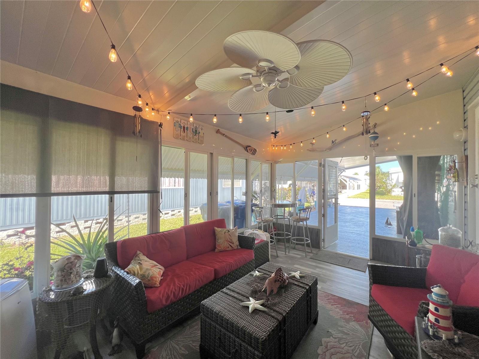 Lanai under carport with glass enclosed windows.