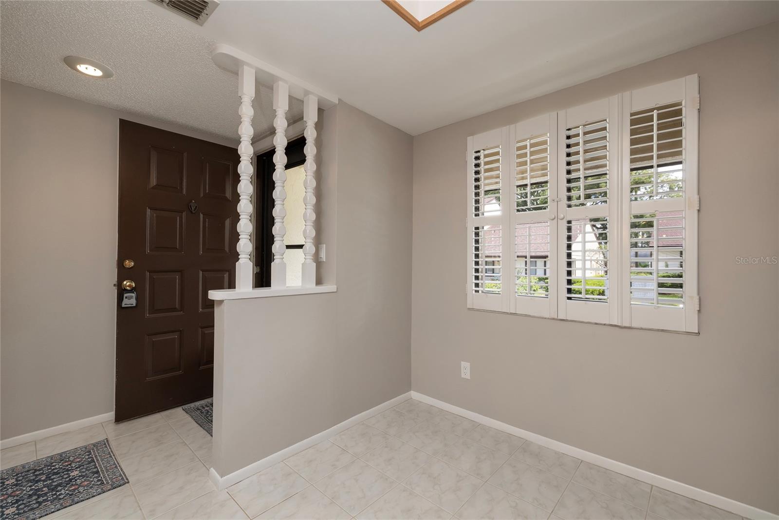 Foyer & eat in space in the kitchen w/ plantation shutters