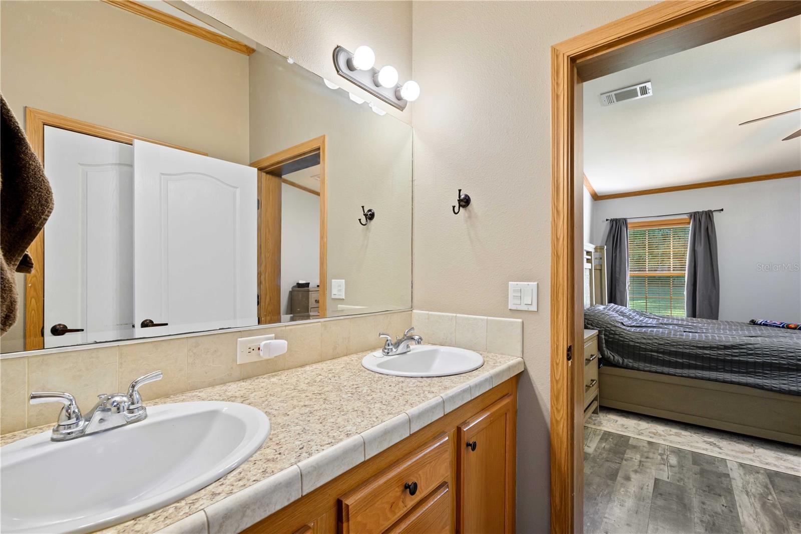 Primary bath has double sinks in vanity.