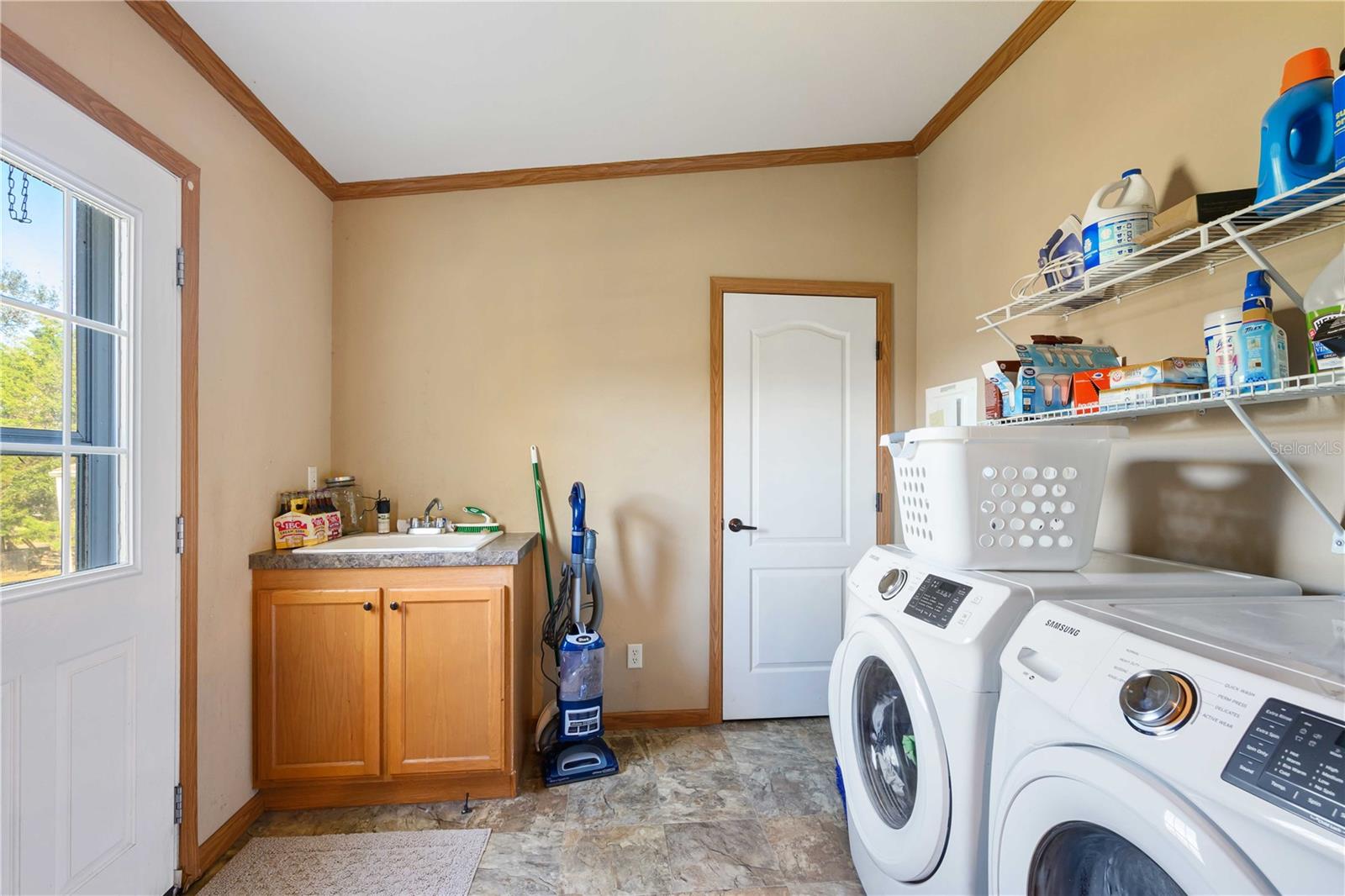 Huge laundry with its own broom closet.