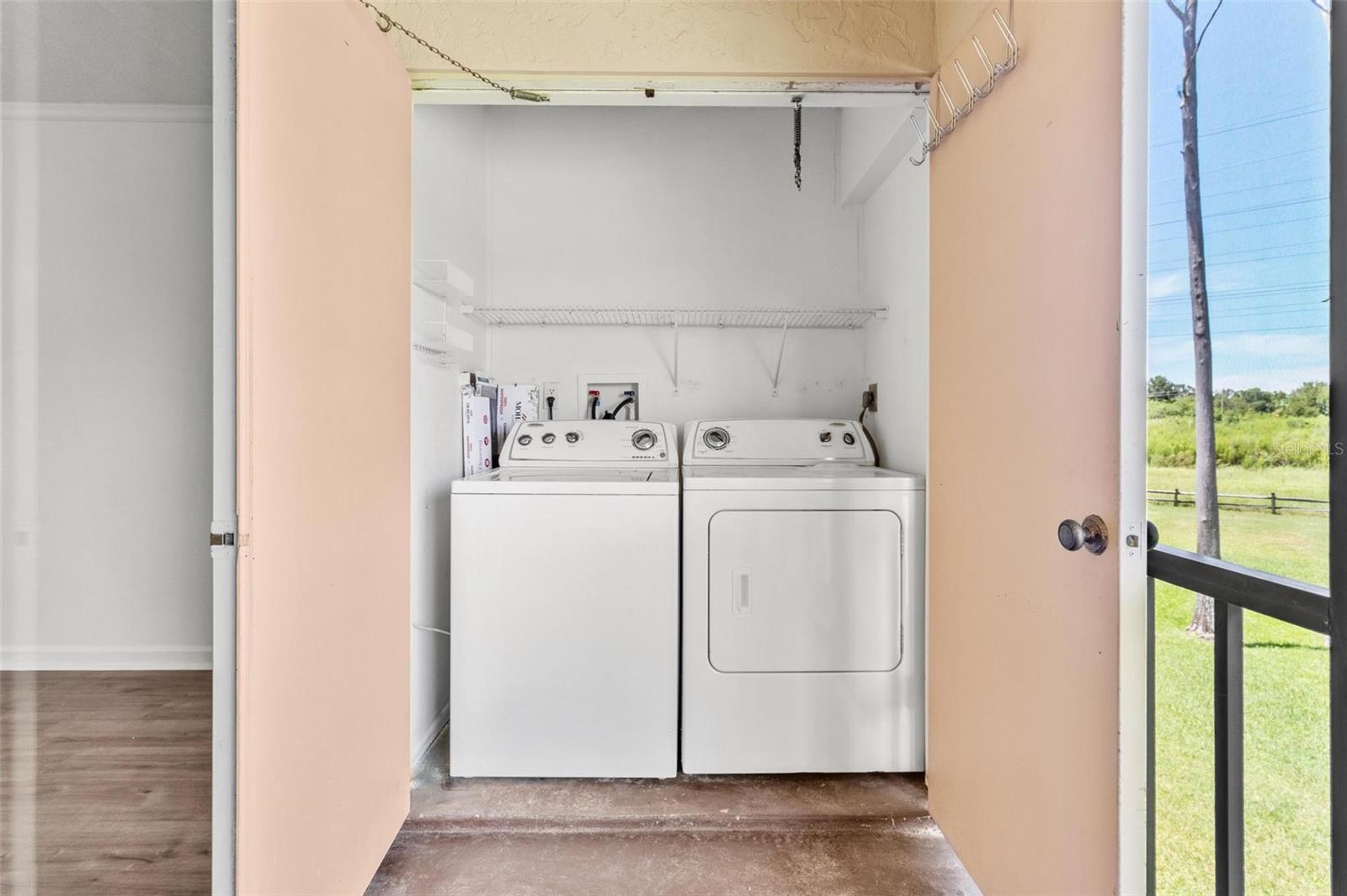 Washer and dryer in closet on back porch