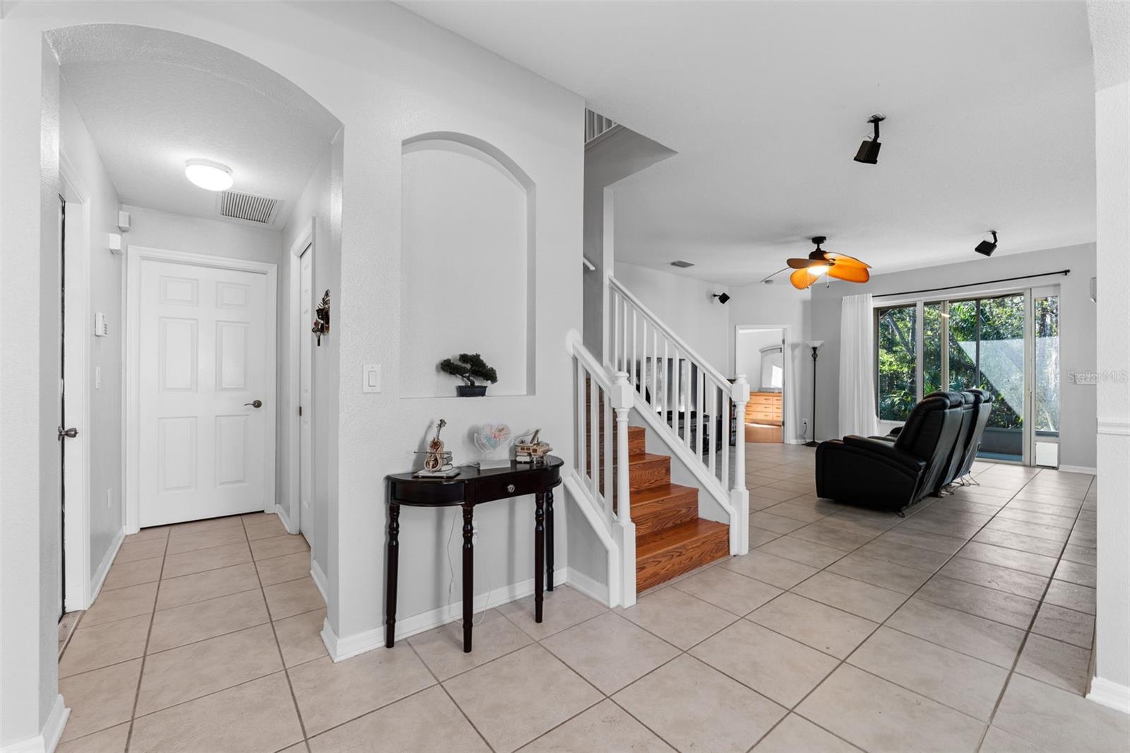 Foyer area with Quick access to the guest bathroom, laundry room, and garage.