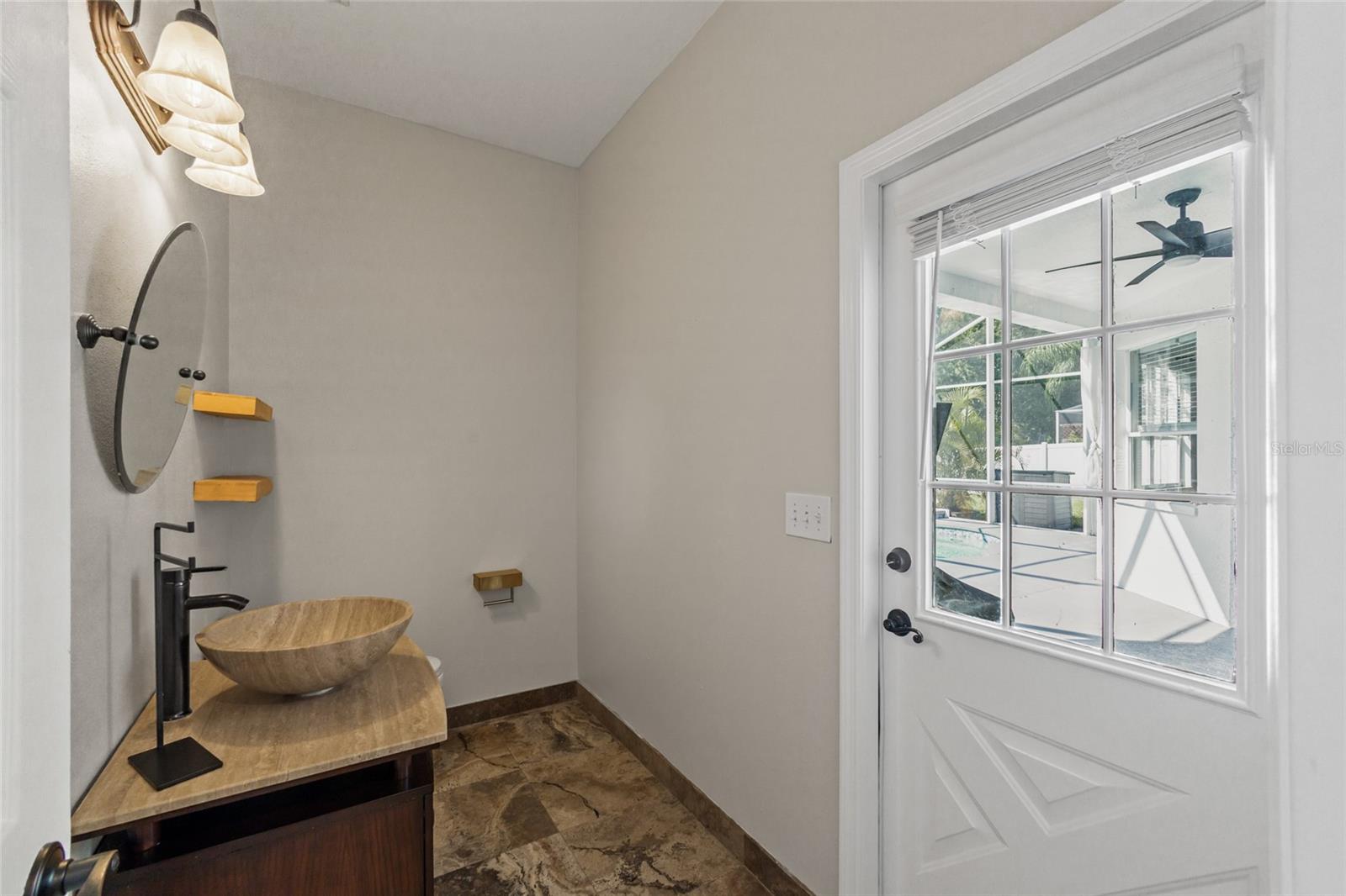 Half Bath 1st Floor next to FAMILY ROOM with private door to outdoor living area.