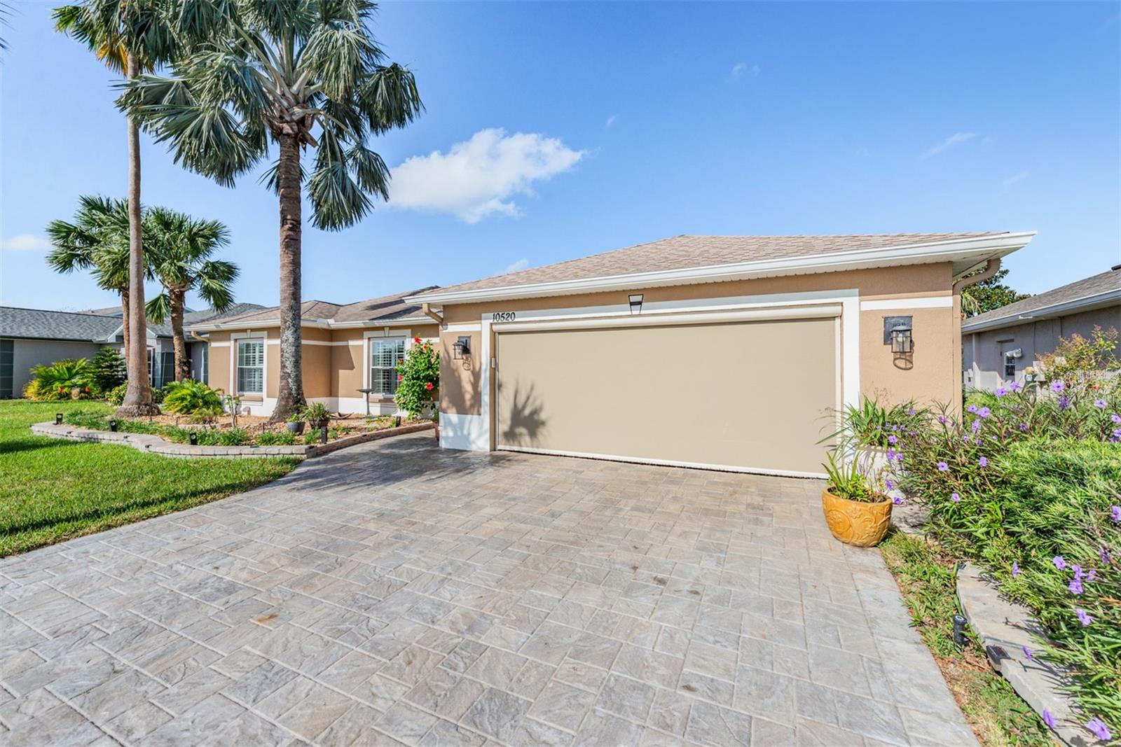 Hip roof for insurance discount and STUNNING PAVER DRIVEWAY with electric privacy screened garage!