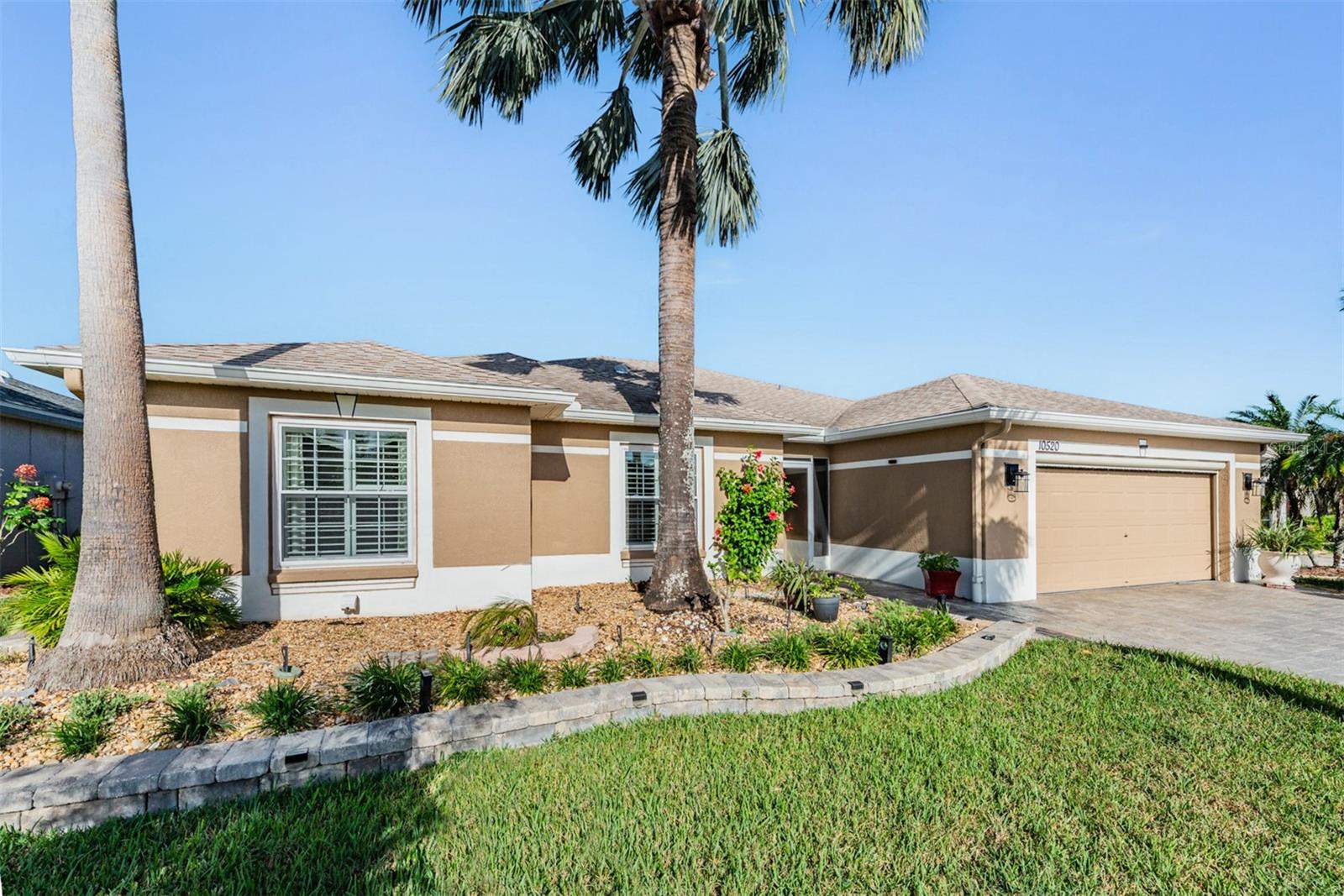 Great Curb Appeal with Brick Wall landscaped bed accent and PAVER driveway and walkway to entrance!