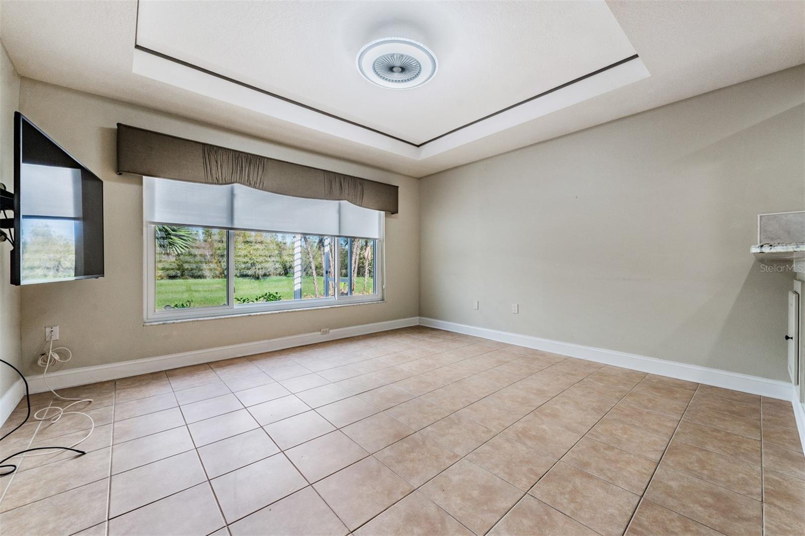 Tray ceiling and Triple window accent this Flex space!