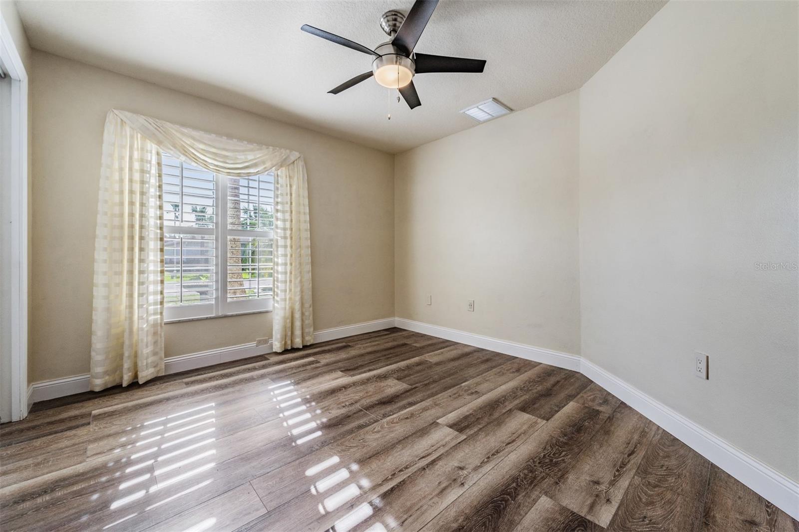 Secondary bedroom with plantation shutter and new floors!