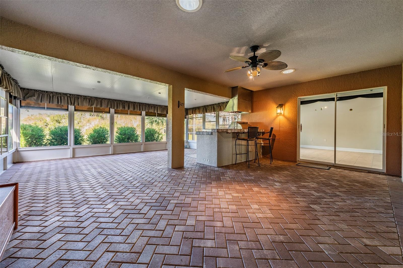 HUGE Enclosed Florida room is GREAT for ENTERTAINING!  PAver floor, Minisplit AC, Outdoor kitchen and Insulated roof!