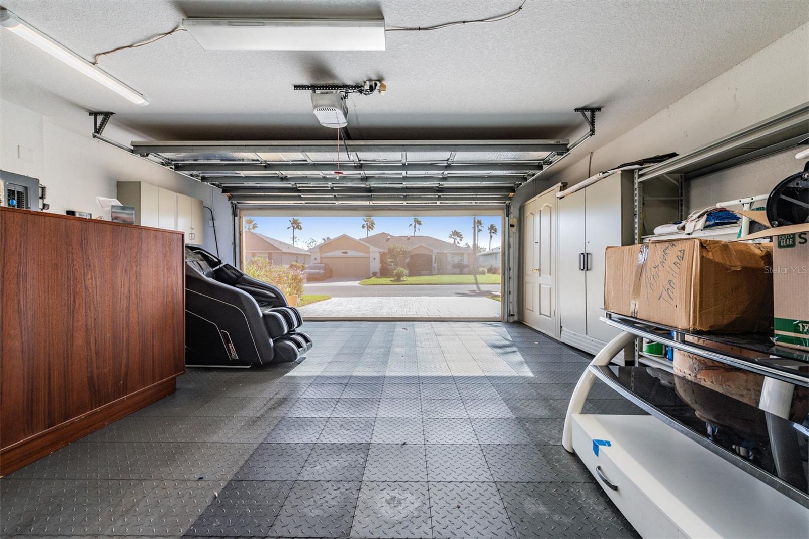 Custom floor in the 2 car garage with electric screened garage