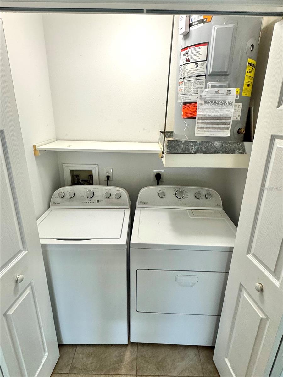 Inside laundry closet with nice washer and dryer