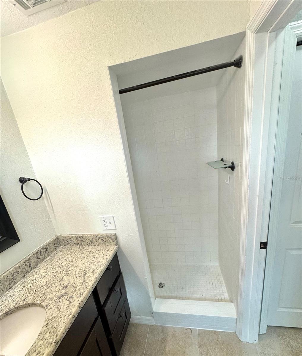 Master bathroom has a stand up shower with updated vanity cabinet and granite counter top.