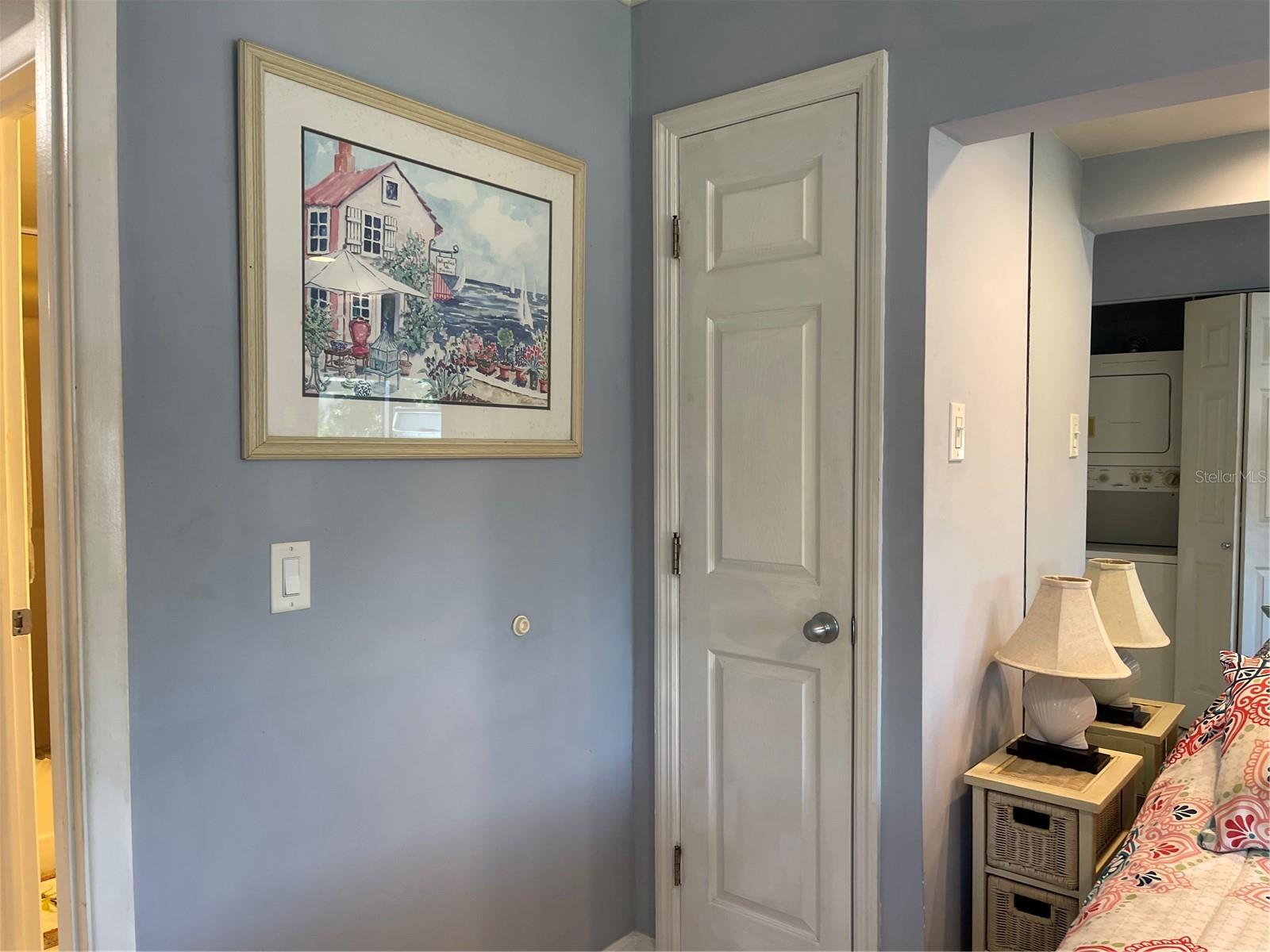 Closets are on both sides of bedroom wall.