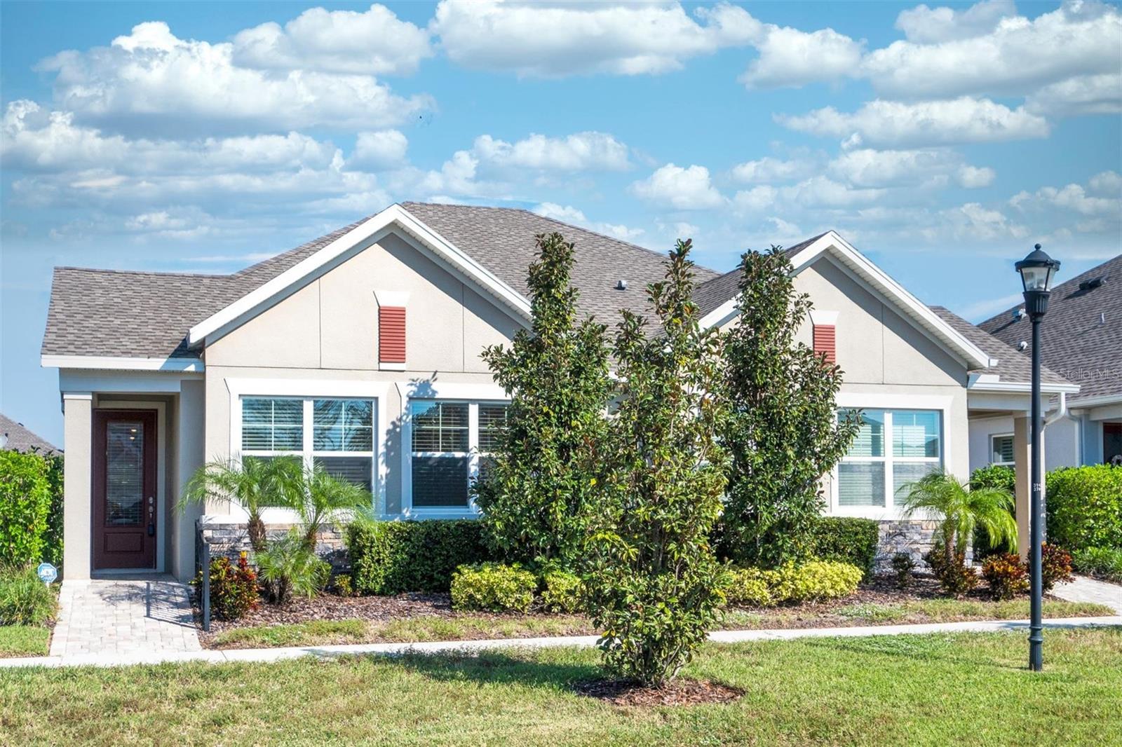 Front Entrance with Covered Porch and Pavered Walkway &  Railing