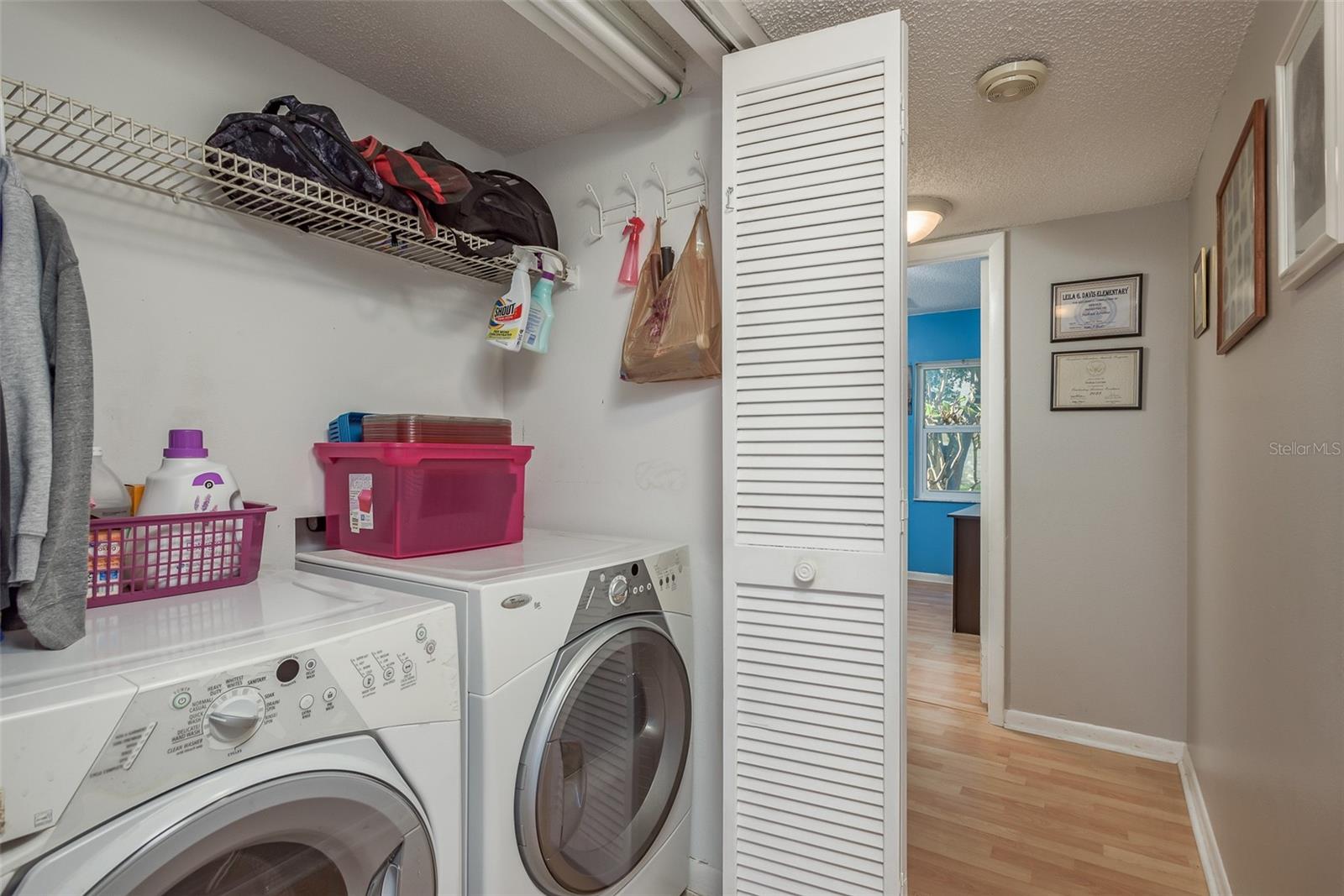 Laundry in the hallway between both bedrooms.