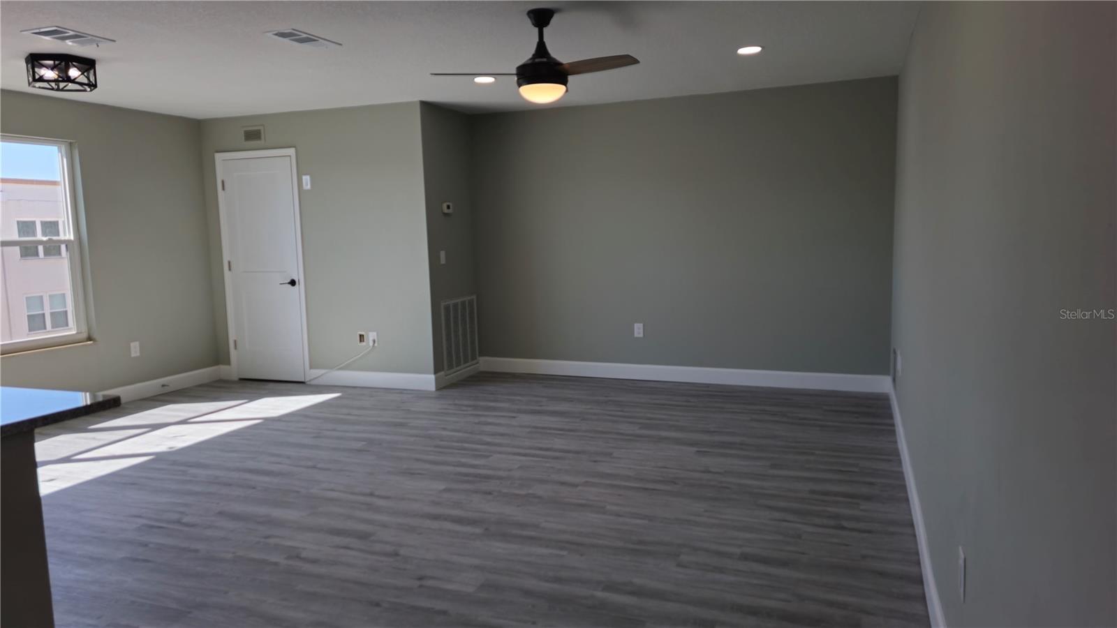 Large, light filled living room with large storage closet