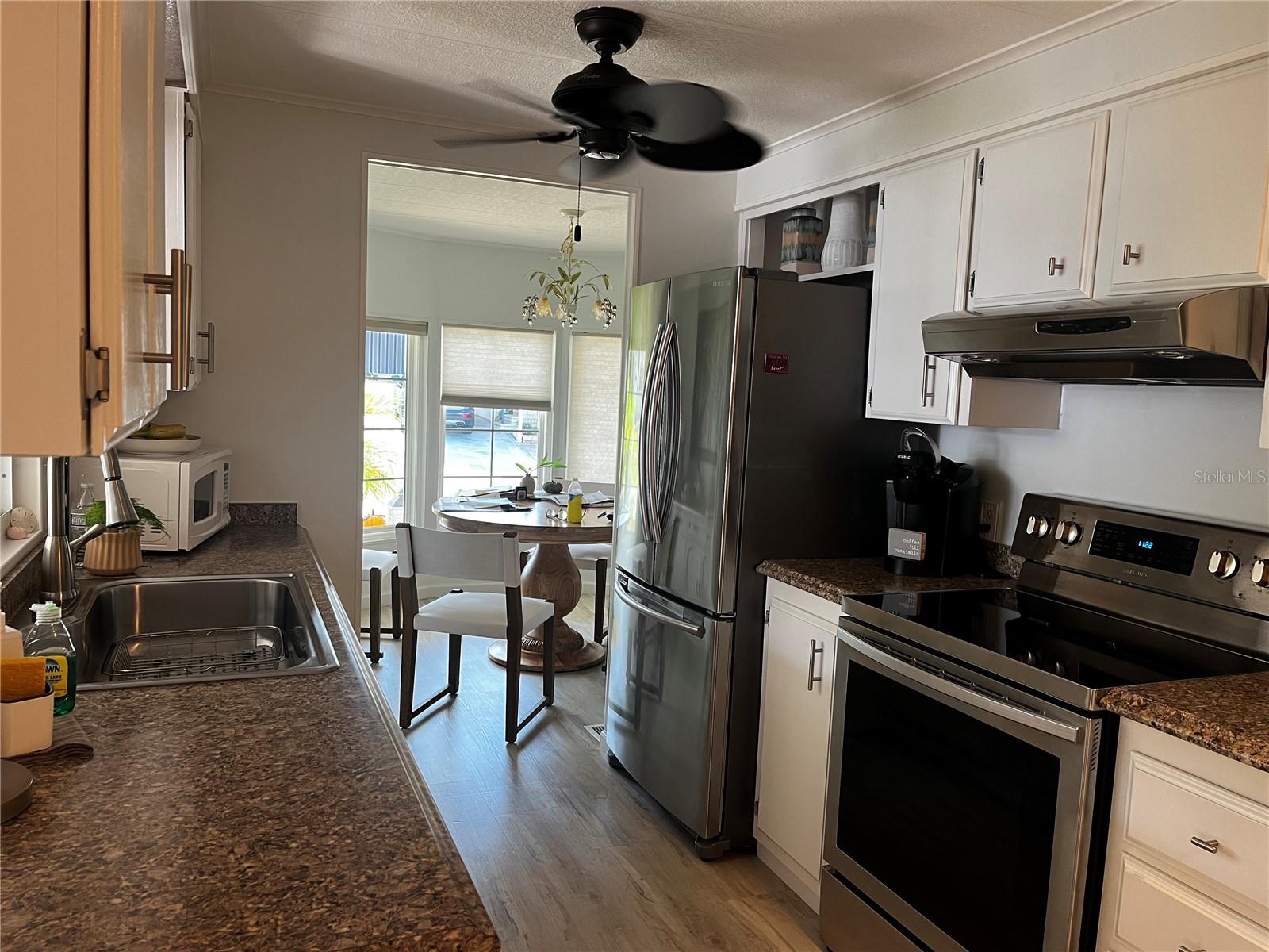 Kitchen with newer refrigerator and range