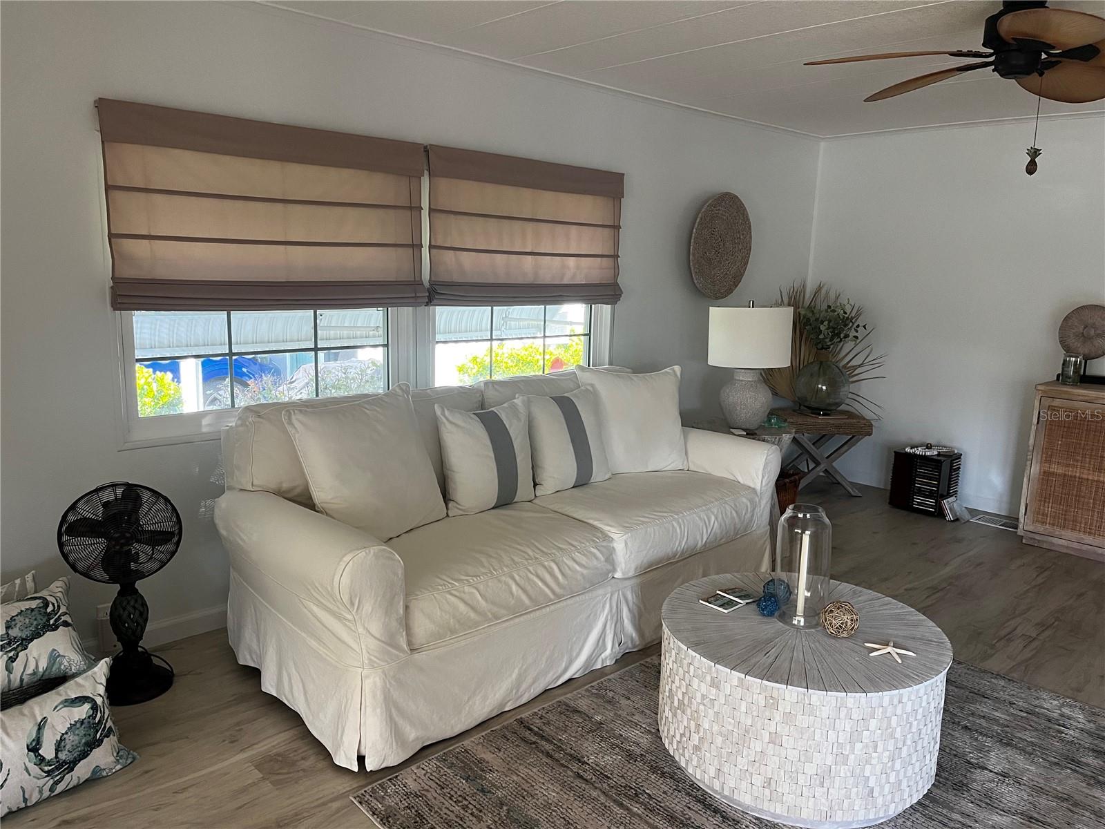 Living room: Roman shade ceiling fan.