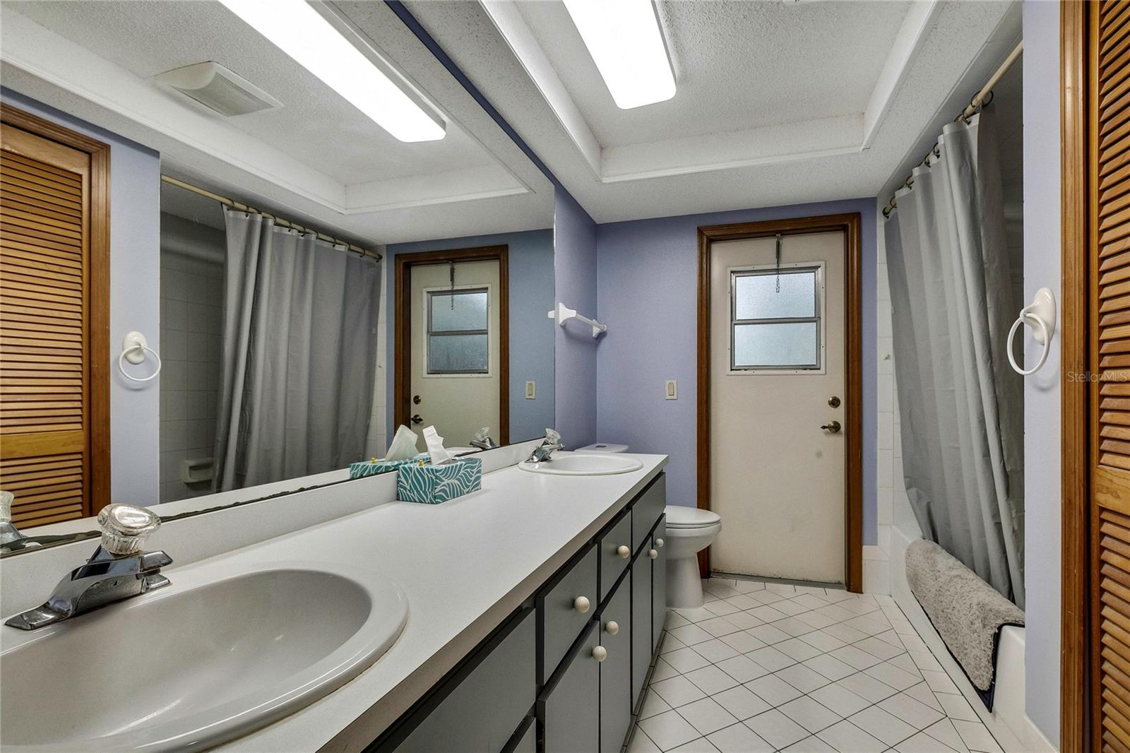 Bathroom with pool access/ dual sinks and tub