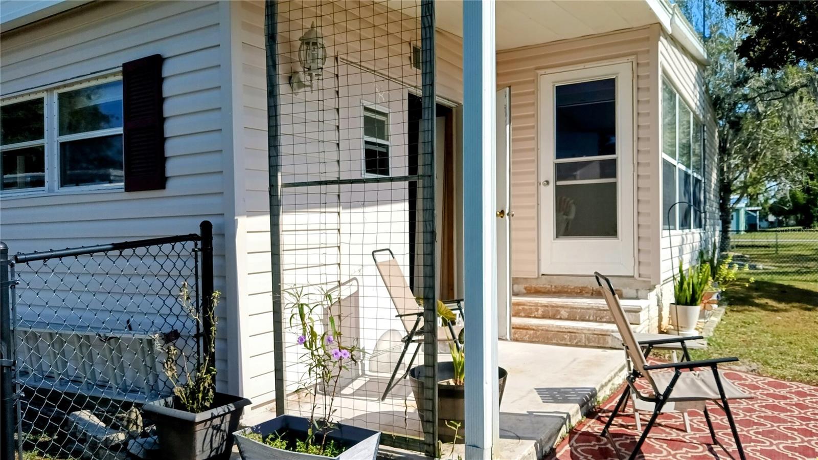 Door leads from the Florida room to the back patio.  The Workshop door is right off the patio.