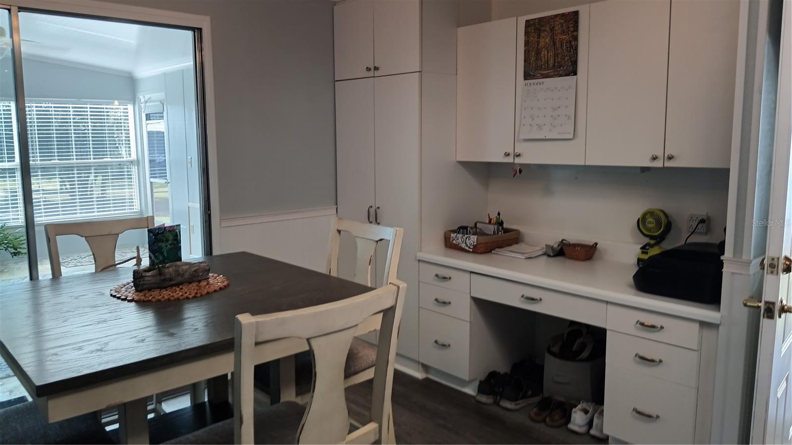 Built in desk and closet pantry in the dining area. Sliding glass doors lead to the back porch.