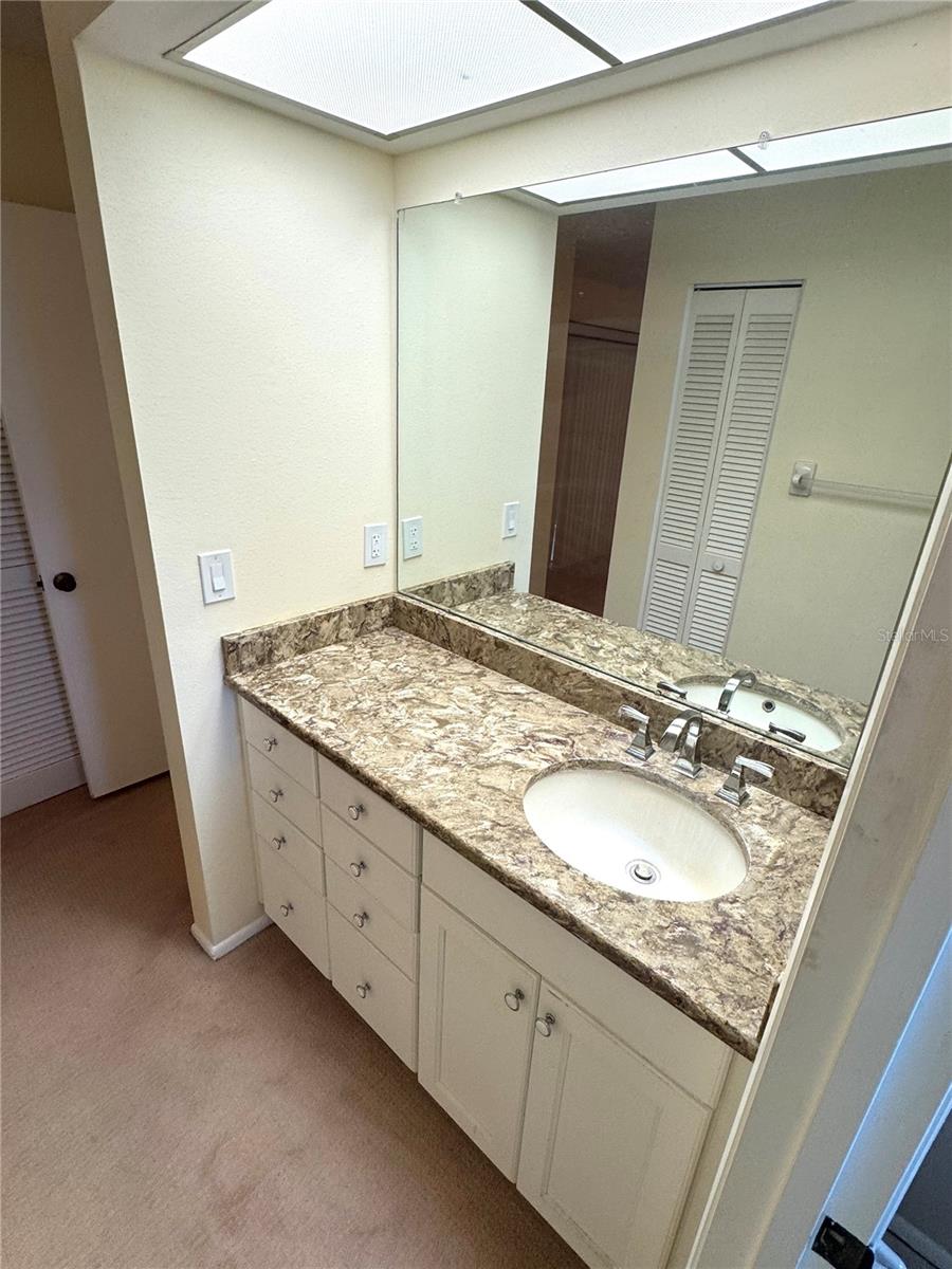 Vanity area is separated from the rest of the bathroom.