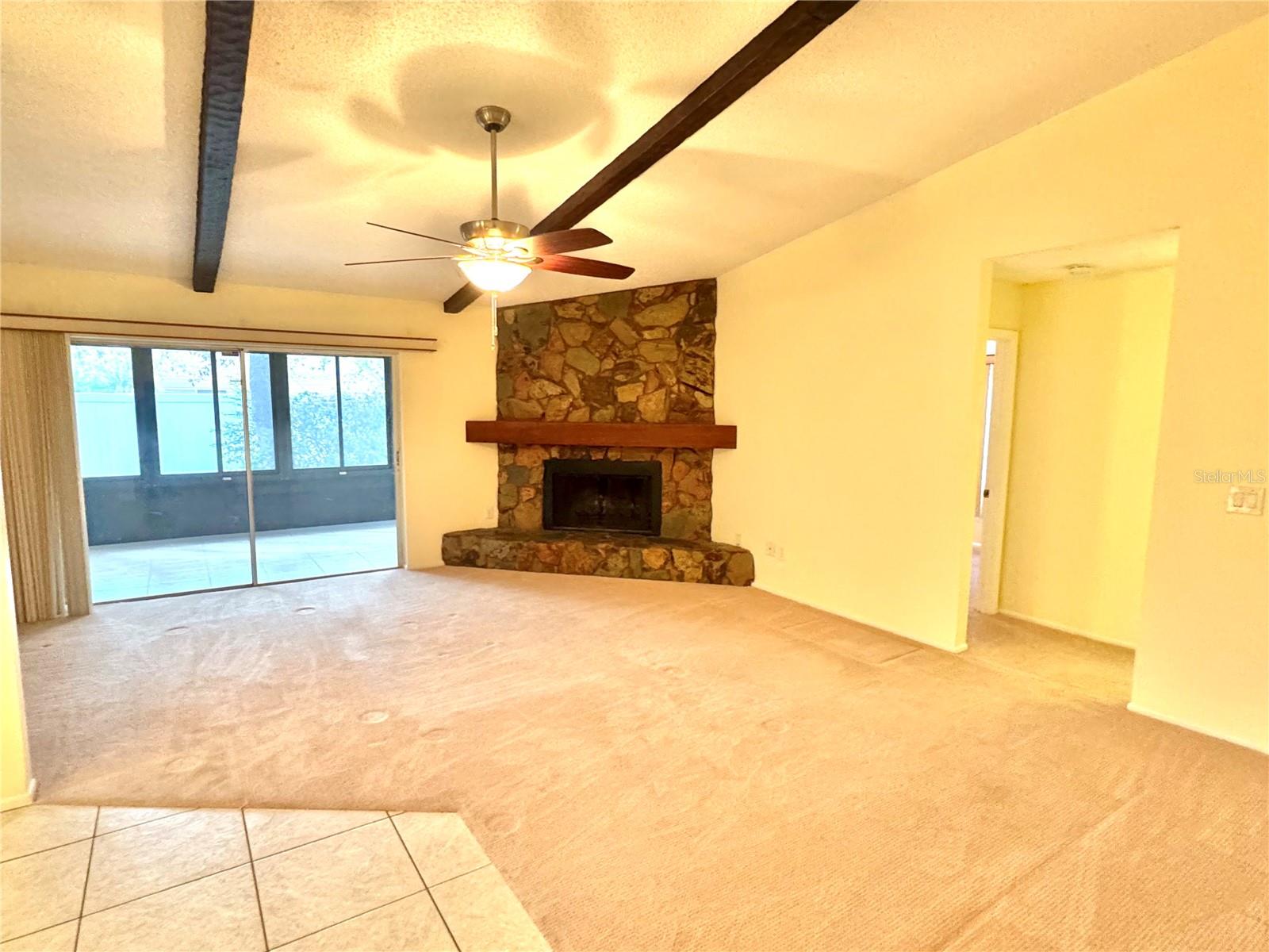 Living room has a wood beams and vaulted ceilings.