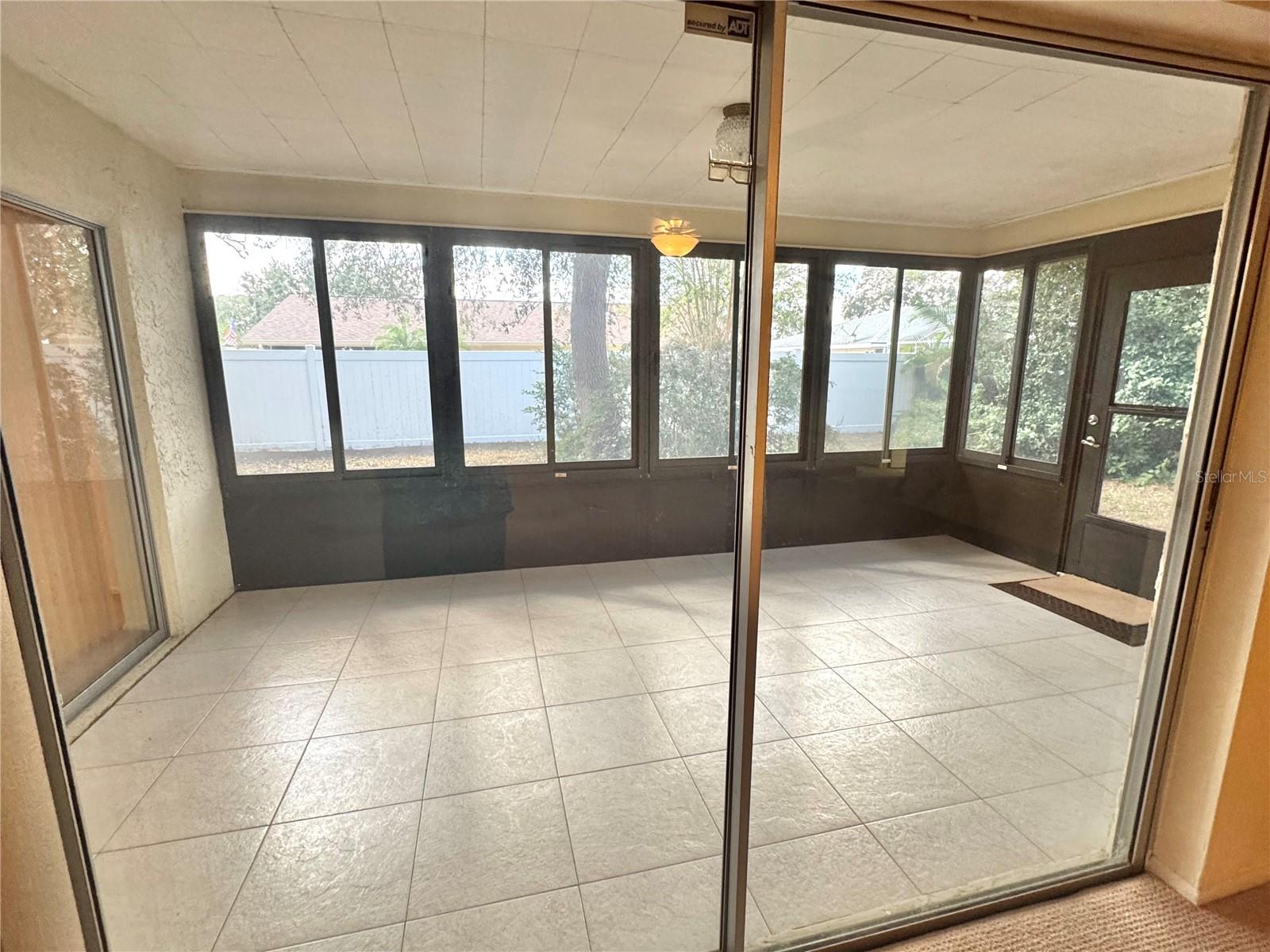 Sliding glass doors lead from the living room out to the large enclosed lanai with side sliding windows.  This area is not air conditioned and is no included in the living square footage of the home.  This is  bonus living area.