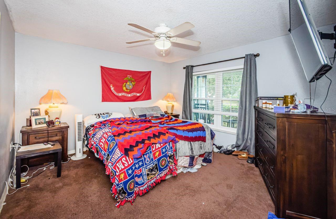 Spacious master bedroom looks out over front yard.