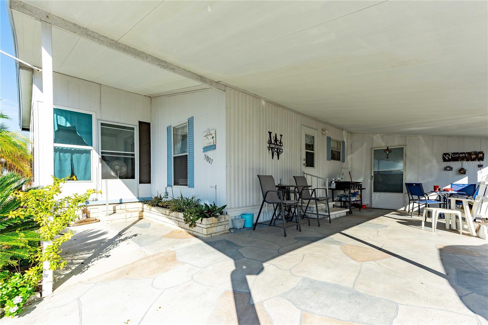 Painted driveway with covered patio area.