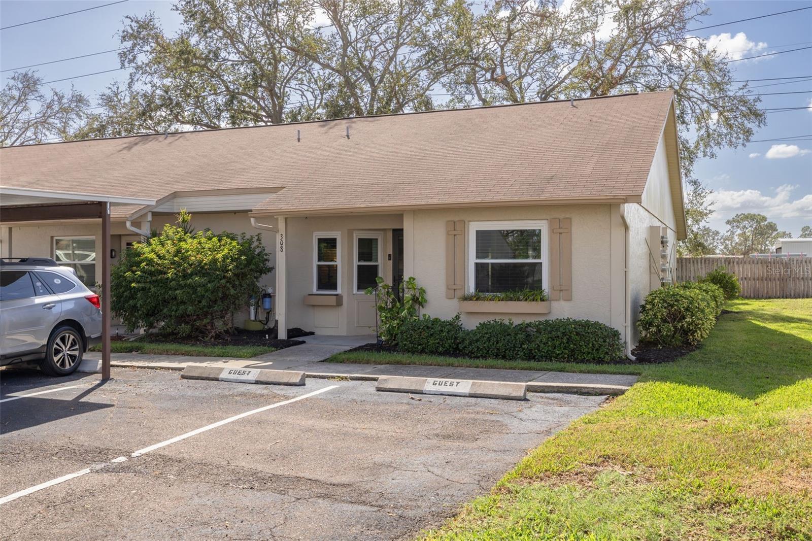 End Unit - Front Entrance with Assigned Carport Parking Space in Front and Guest Spaces