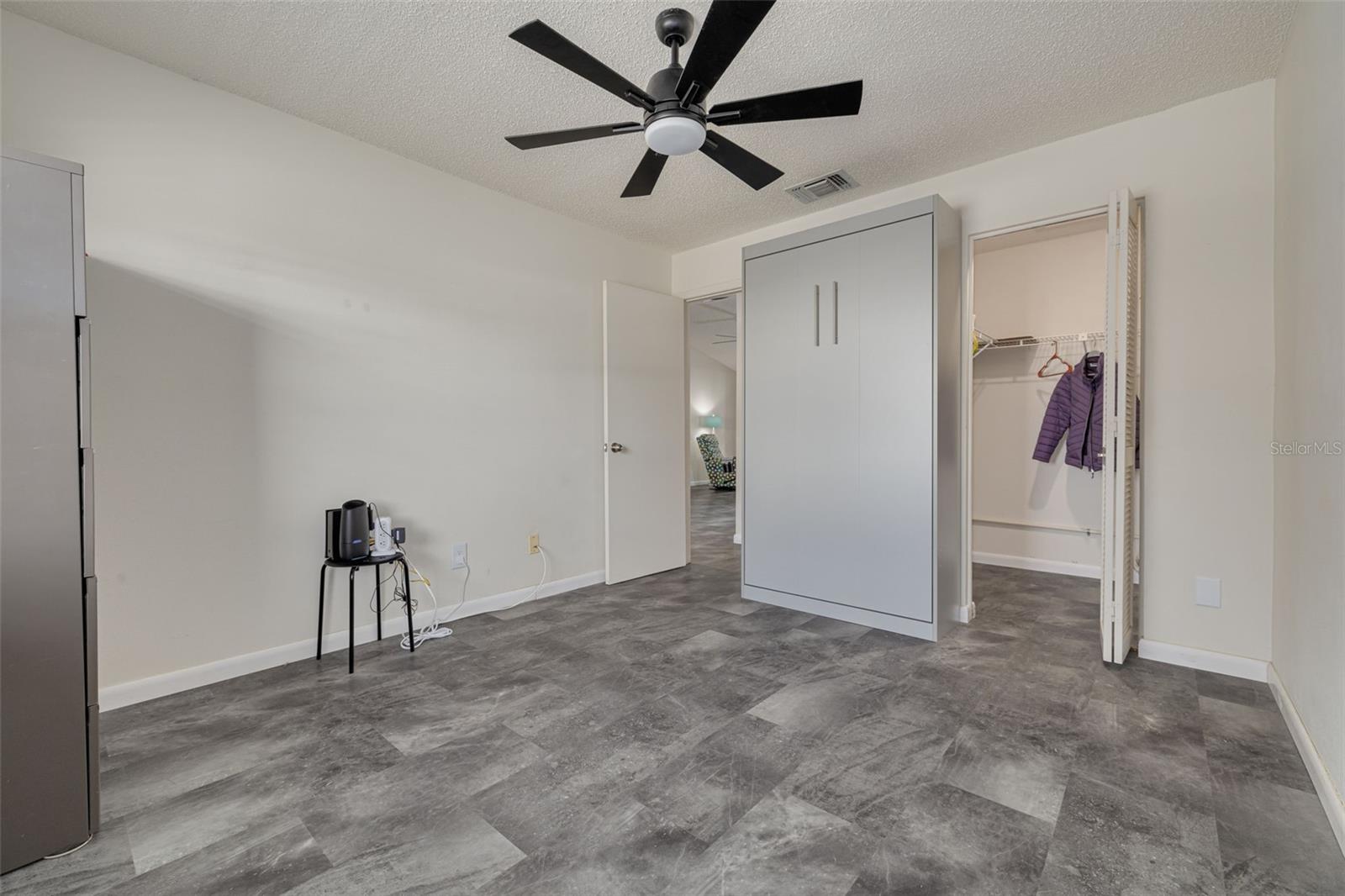 Bedroom 2 with Built-In Murphy Bed and View of Walk-in Closet