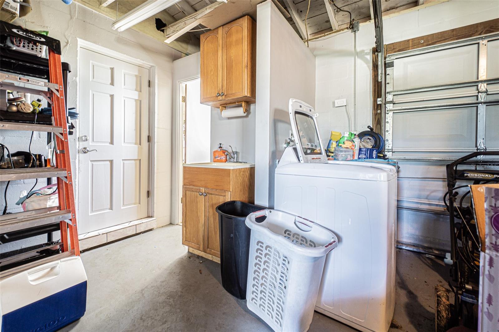 Extra sink, washer and dryer in oversized garage.