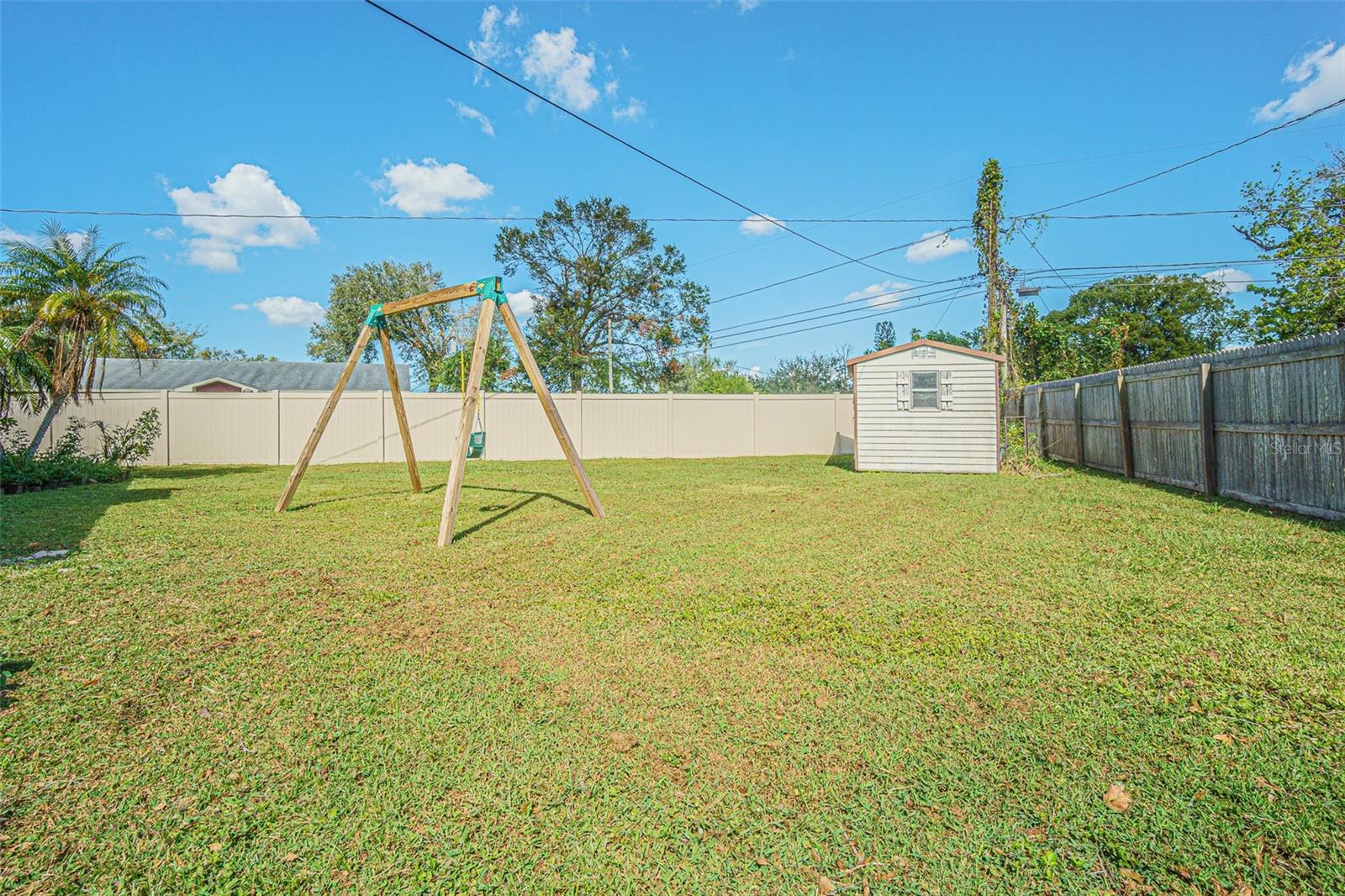 Shed and fenced backyard.