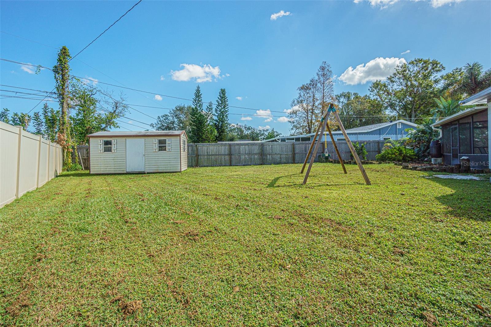 Shed and fenced backyard.