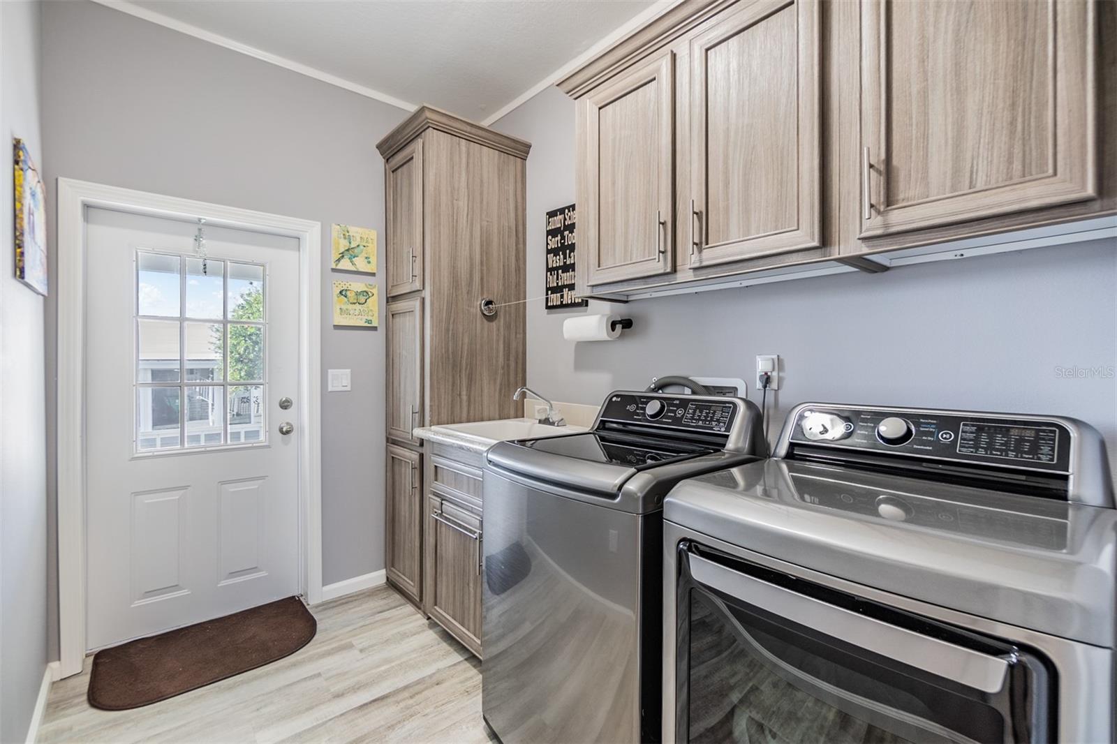 Interior Laundry room with exit door to carport