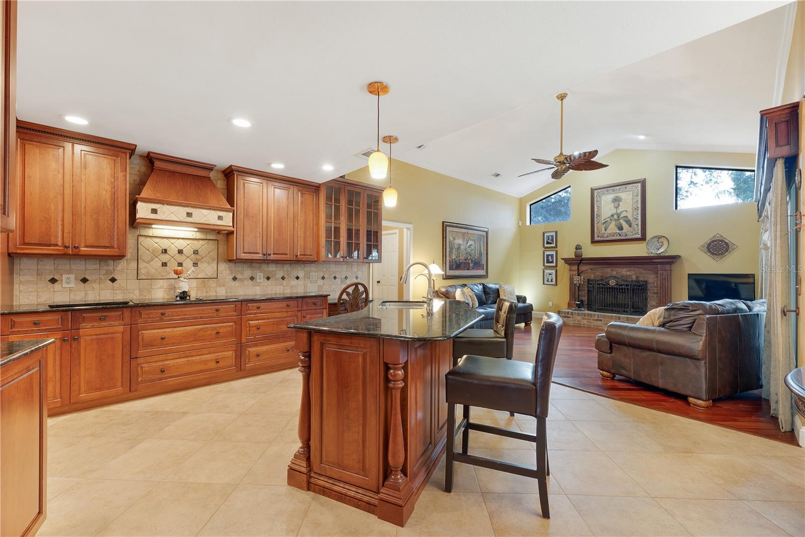 Kitchen is open to family room.  Cherry wood cabinets with several deep drawers, a glass display cabinet and well crafted moldings.