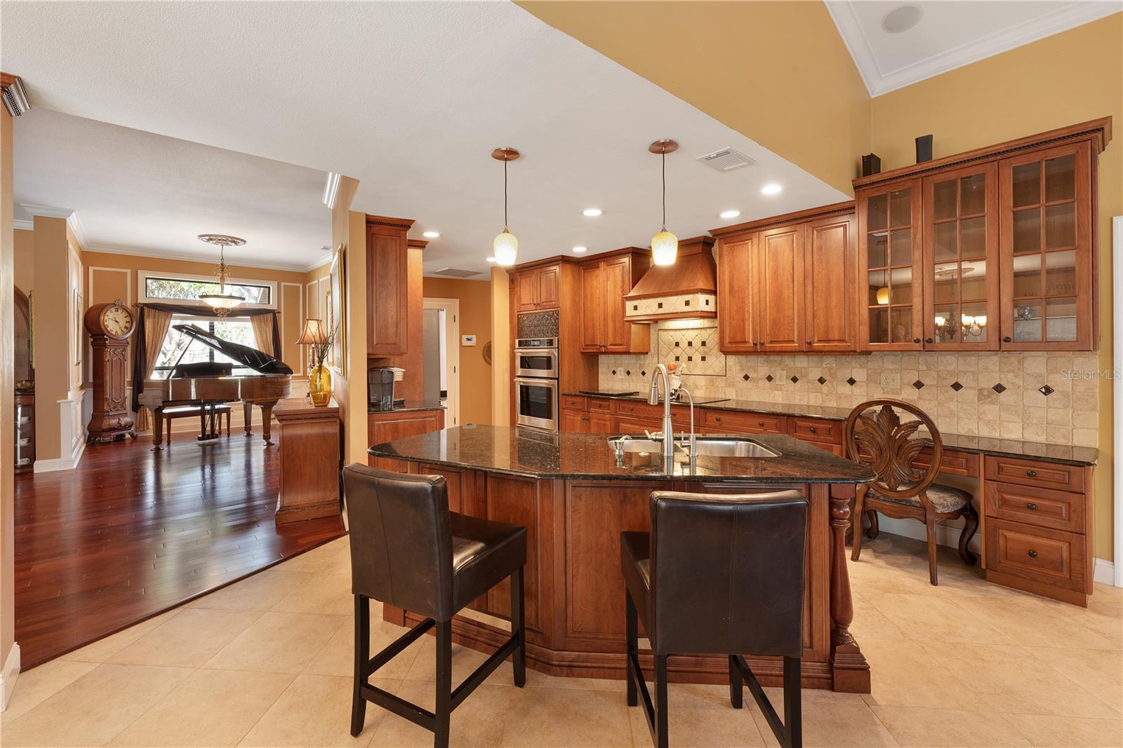 This kitchen boasts tons of granite topped work surface as well as a built in desk.